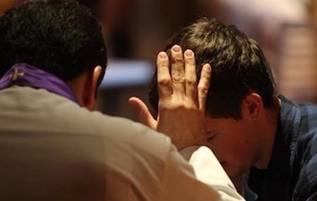 Parishioner receives absolution in Confession.