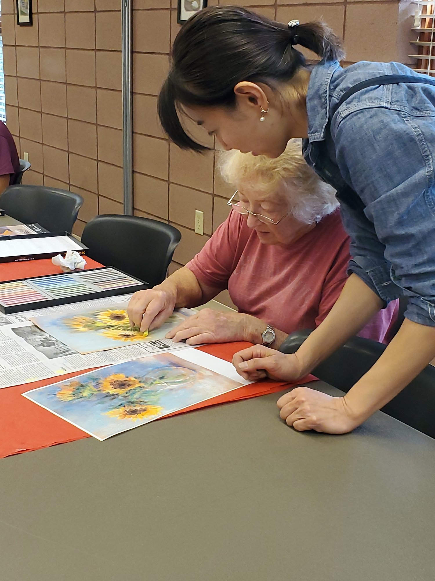 watercolor student being taught by instructor