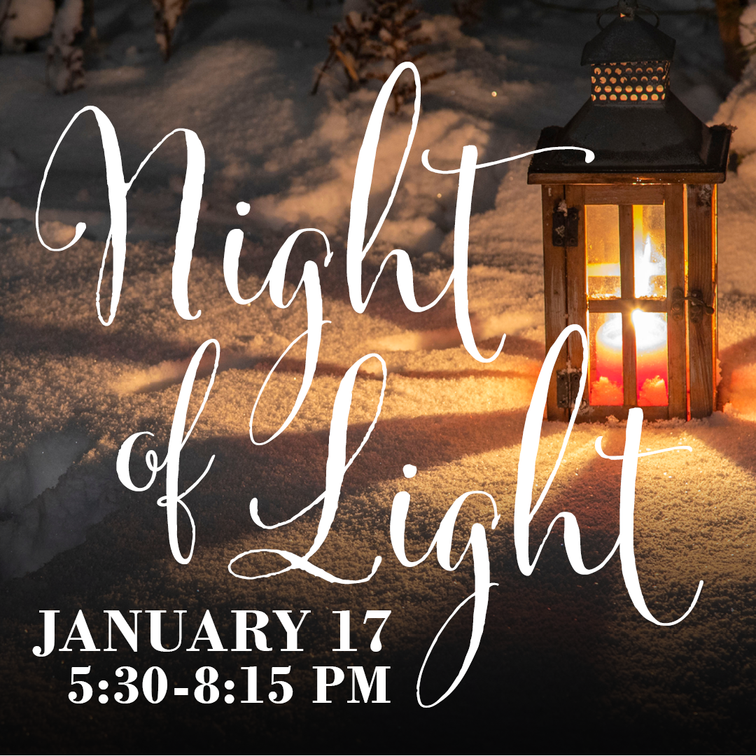 Lit lantern in the snow with 
