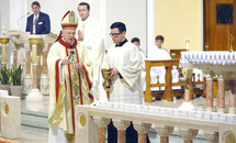 Altar servers prepare the table for the Eucharist