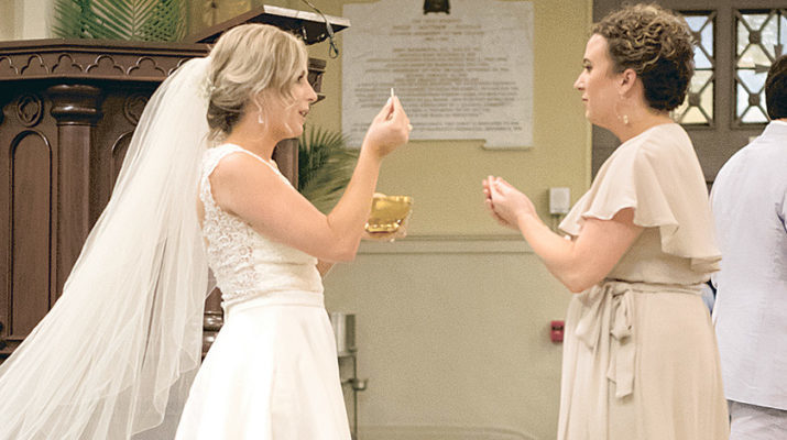 Bride and groom offer Bread of Life at wedding
