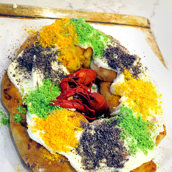 Deacon Levy shares faith, crawfish king cake