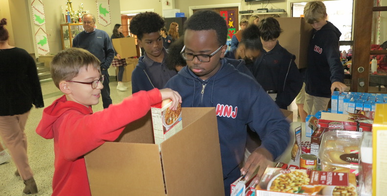 Holy Name of Jesus students fill boxes with food, love