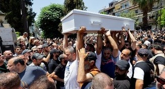 Families mourn victims of a massacre in a Damascus church, blame Syrian government