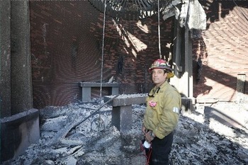 Fire captain makes way through ruins of incinerated church to find tabernacle intact