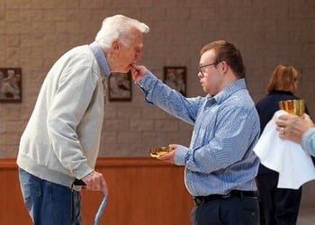 With reverence, contagious smile, volunteer with Down syndrome inspires Michigan parish