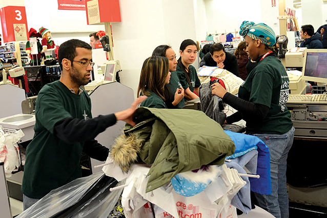 Catholic Charities volunteers buying Christmas gifts for clients of the Adopt-a-Family program.