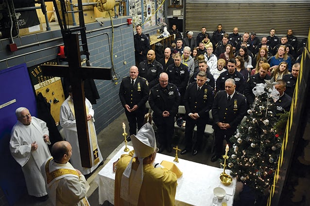 Serving those who serve: Cardinal Dolan celebrates Christmas Eve Mass with members of the NYPD Service Emergency Unit.