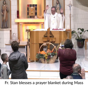Fr. Stan blesses a prayer blanket during Mass.