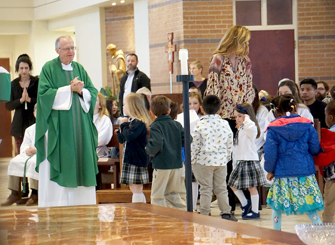 image of children walking to priest for children's church