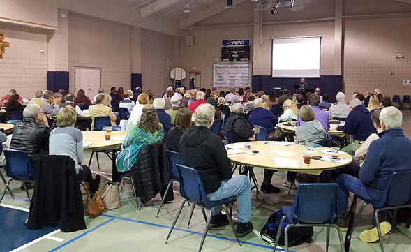 image of group of participants in Christ Life program at tables in FLC