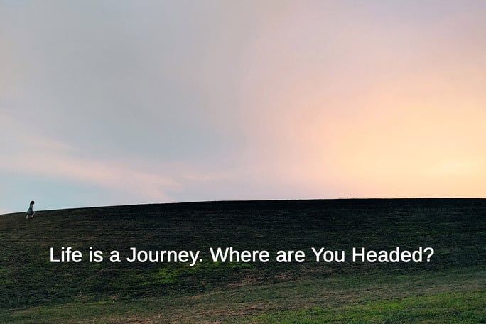 image of woman walking uphill at sunset