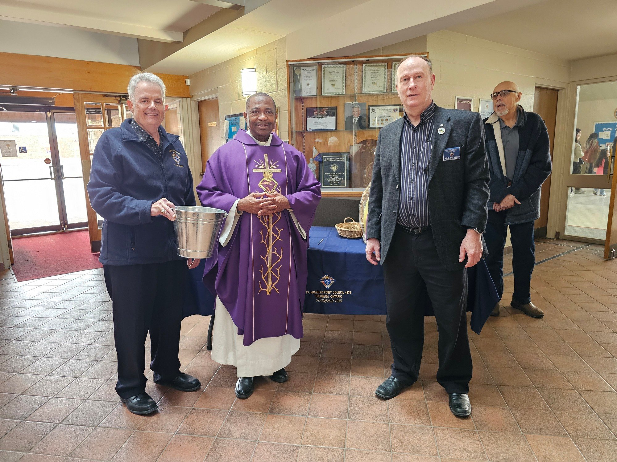 Our Grand Knight Ron Couvillion and Deputy Grand Knight Carl Baillargeon and Father Kieran Drawing Winning Ticket For Easter Basket