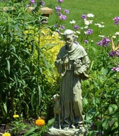 St Francis statue in blooming garden at Franciscan Retreats and Spirituality Center in Prior Lake, MN