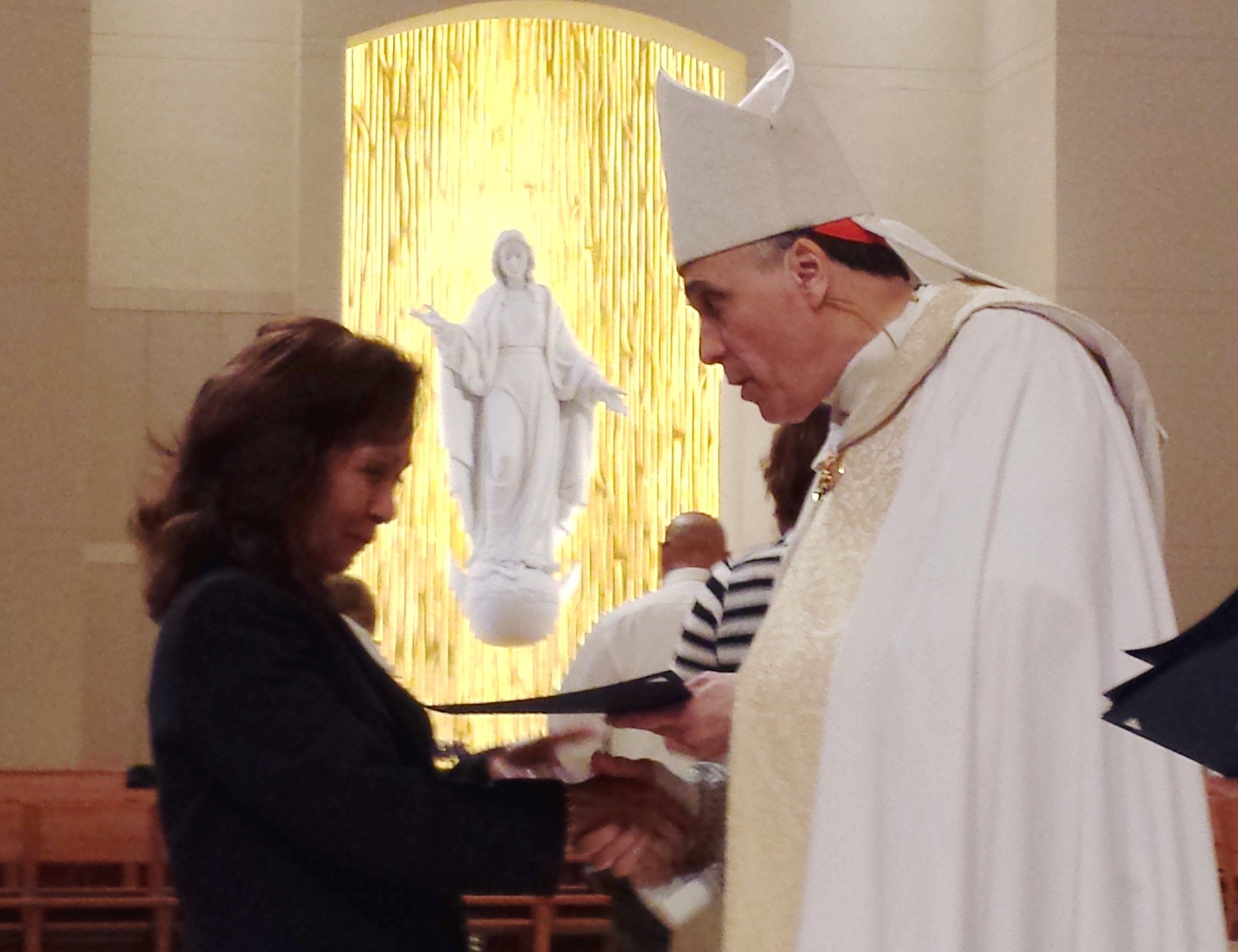 Cardinal DiNardo handing a catechist certificate