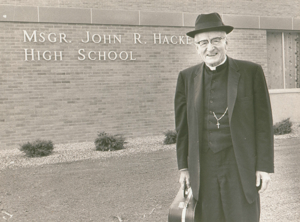 Monsignor John R. Hackett Standing Outside of Hackett High School