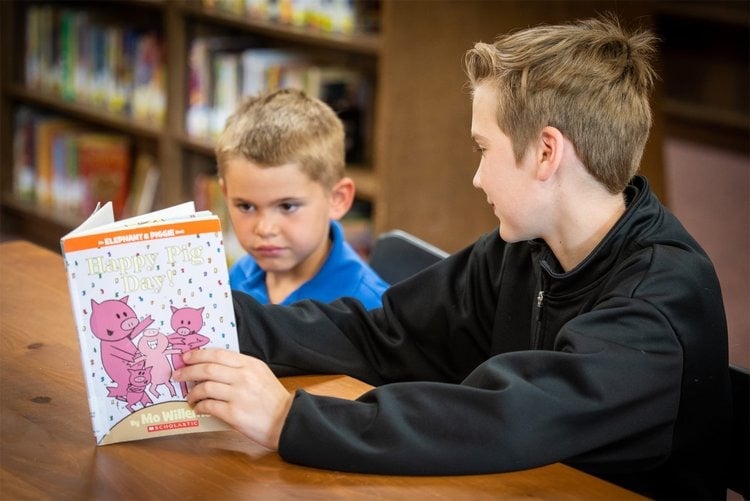 Buddy reading to a younger student