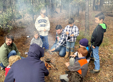 Catholic fathers and sons bond, experience God in outdoors