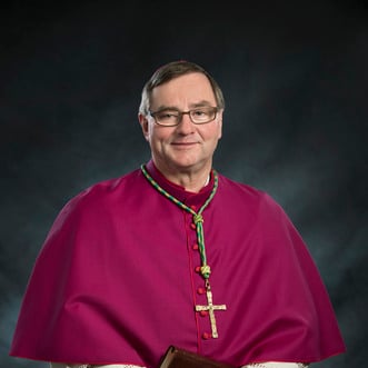 Father Ricci blessing cross in class